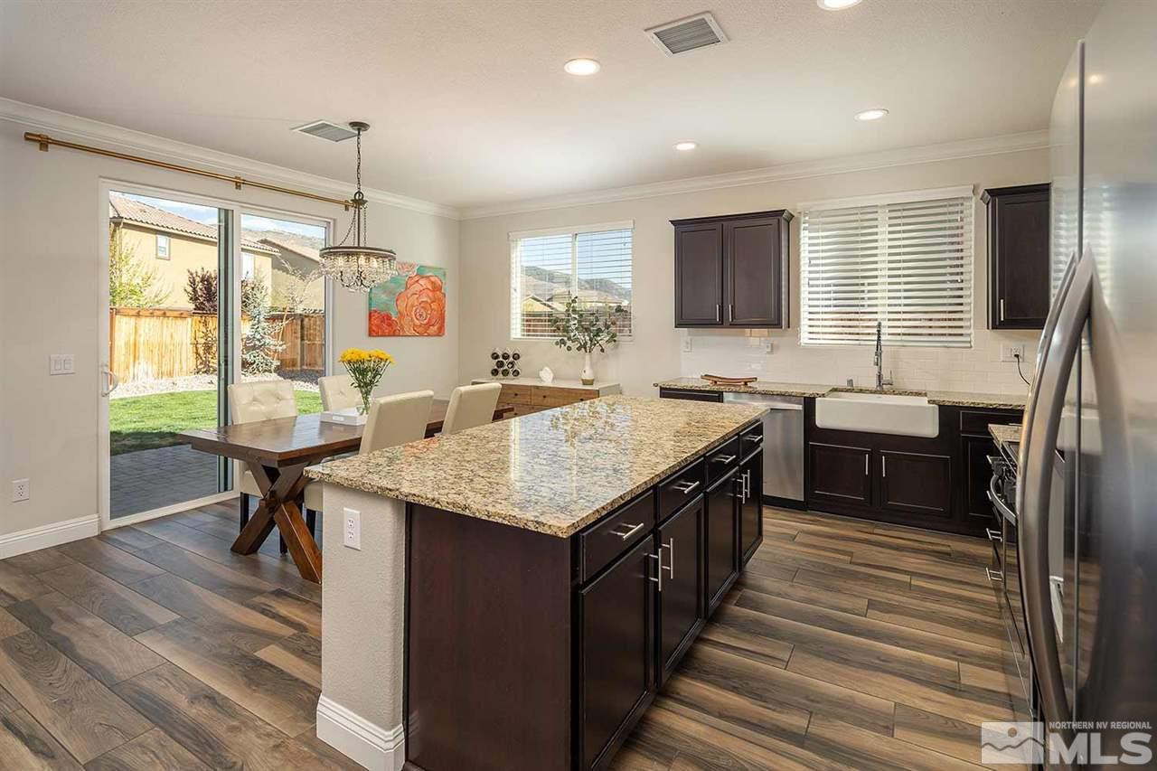 2820 Show Jumper Lane Reno, NV 89521 - Photo 16 of 40 a kitchen with stainless steel appliances granite countertop a kitchen island a stove and a sink