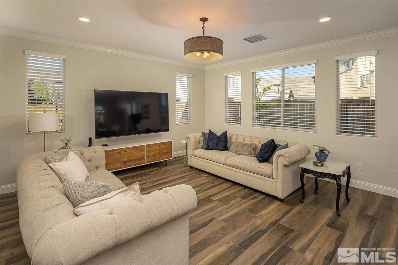 2820 Show Jumper Lane Reno, NV 89521 - Photo 3 of 40 a living room with furniture a flat screen tv and a large window