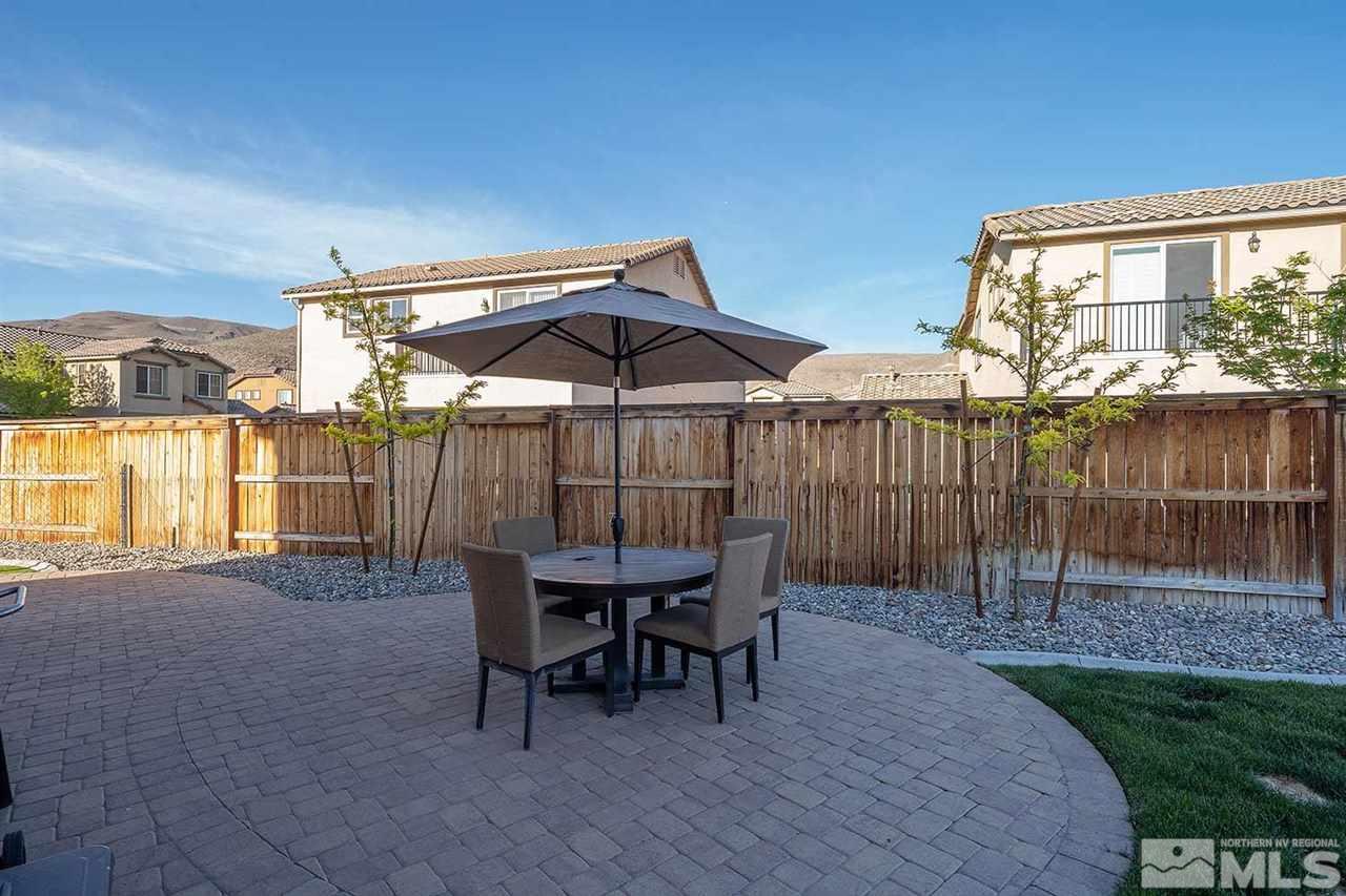 2820 Show Jumper Lane Reno, NV 89521 - Photo 10 of 40 a patio with wooden floor a yard a table and chairs