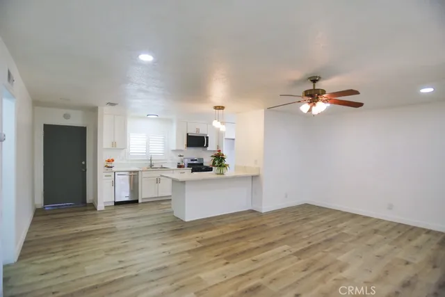 a kitchen with a sink cabinets and wooden floor