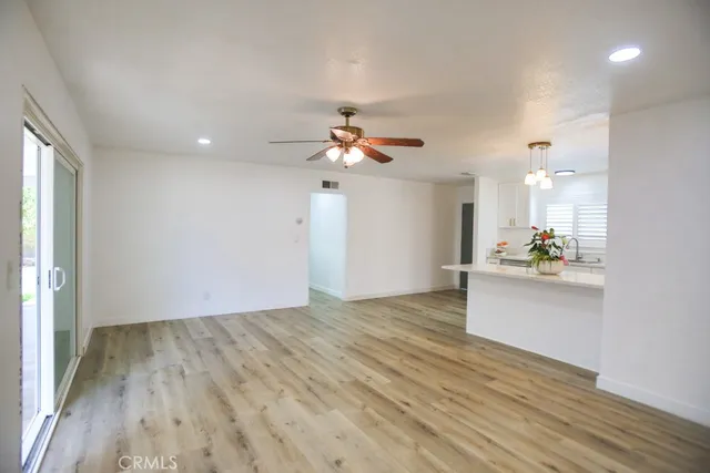a view of a kitchen with a sink and a chandelier fan