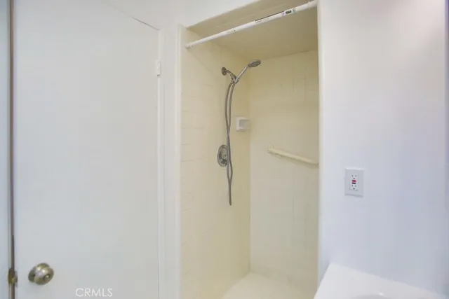 a bathroom with a sink a mirror and a shower