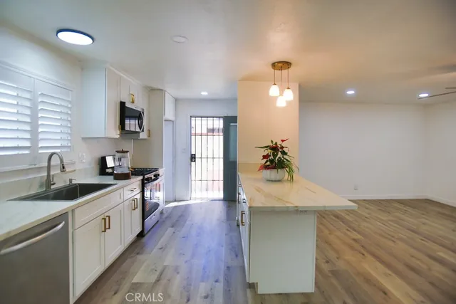 a kitchen with a sink stove and cabinets