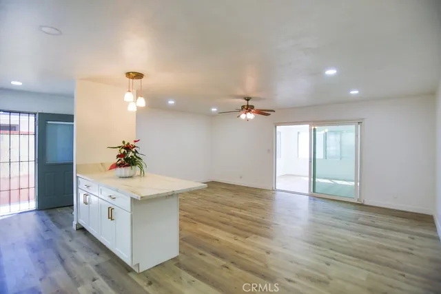 a view of entryway with kitchen and wooden floor