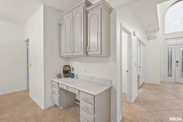 a kitchen with a table chairs microwave and cabinets