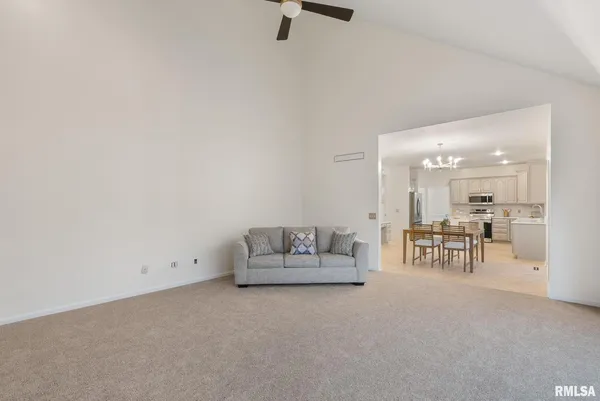 a room with wooden floor and chandelier
