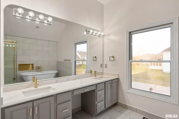 a bathroom with a double vanity sink a toilet and a mirror