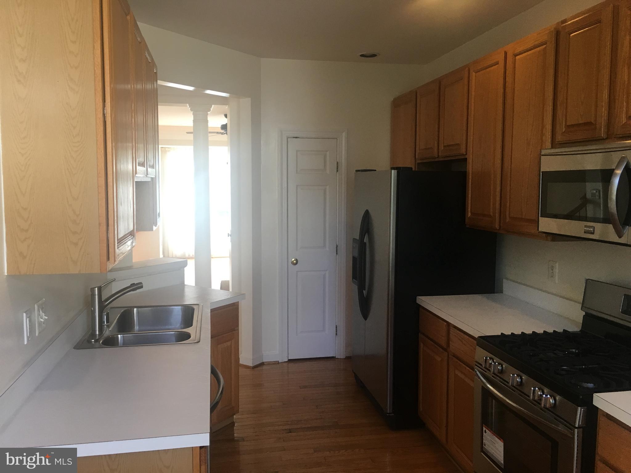 5801 Summers Grove Road Alexandria, VA 22304 - Photo 7 of 27 a kitchen with granite countertop a refrigerator and a sink