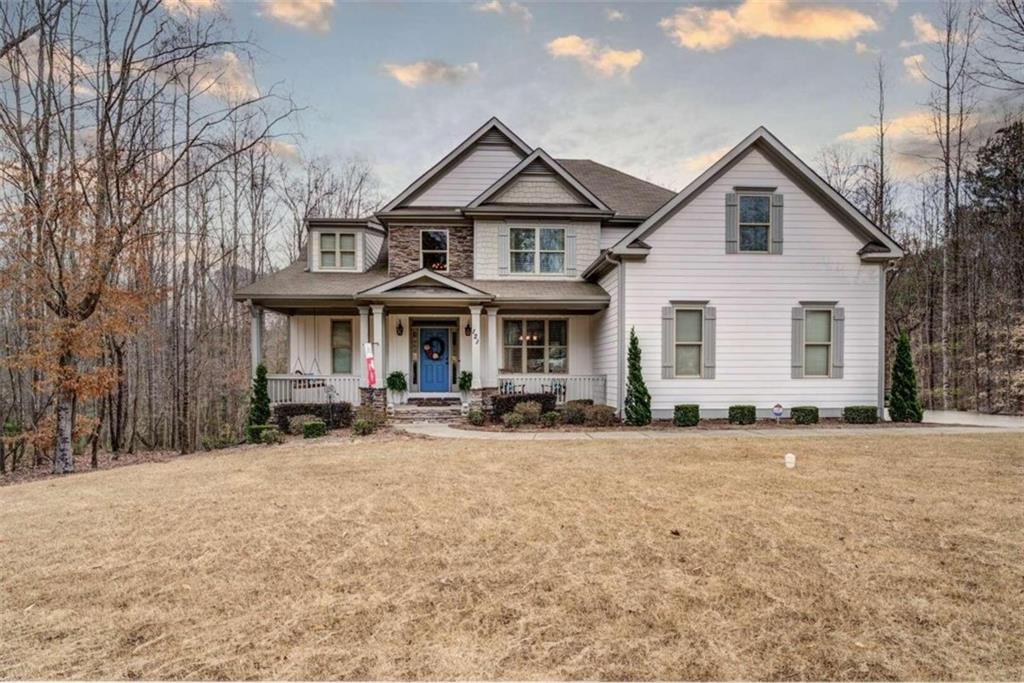 121 Spring Creek Drive Rutledge, GA 30663 - Photo 1 of 1 a front view of a house with sitting area and garage