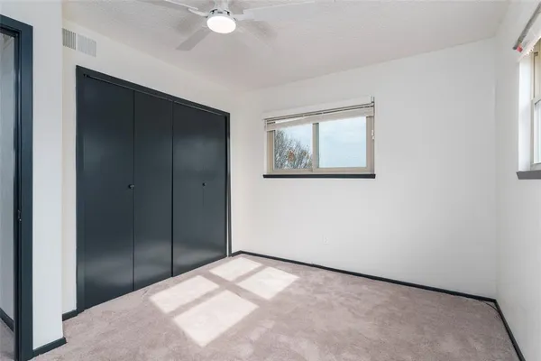 a view of an empty room with a cabinet