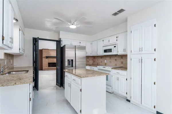 a kitchen with cabinets and stainless steel appliances