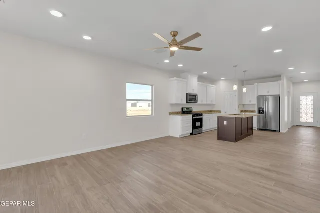 a view of an empty room with a ceiling fan