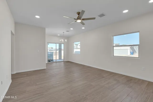 a living room with furniture and kitchen view