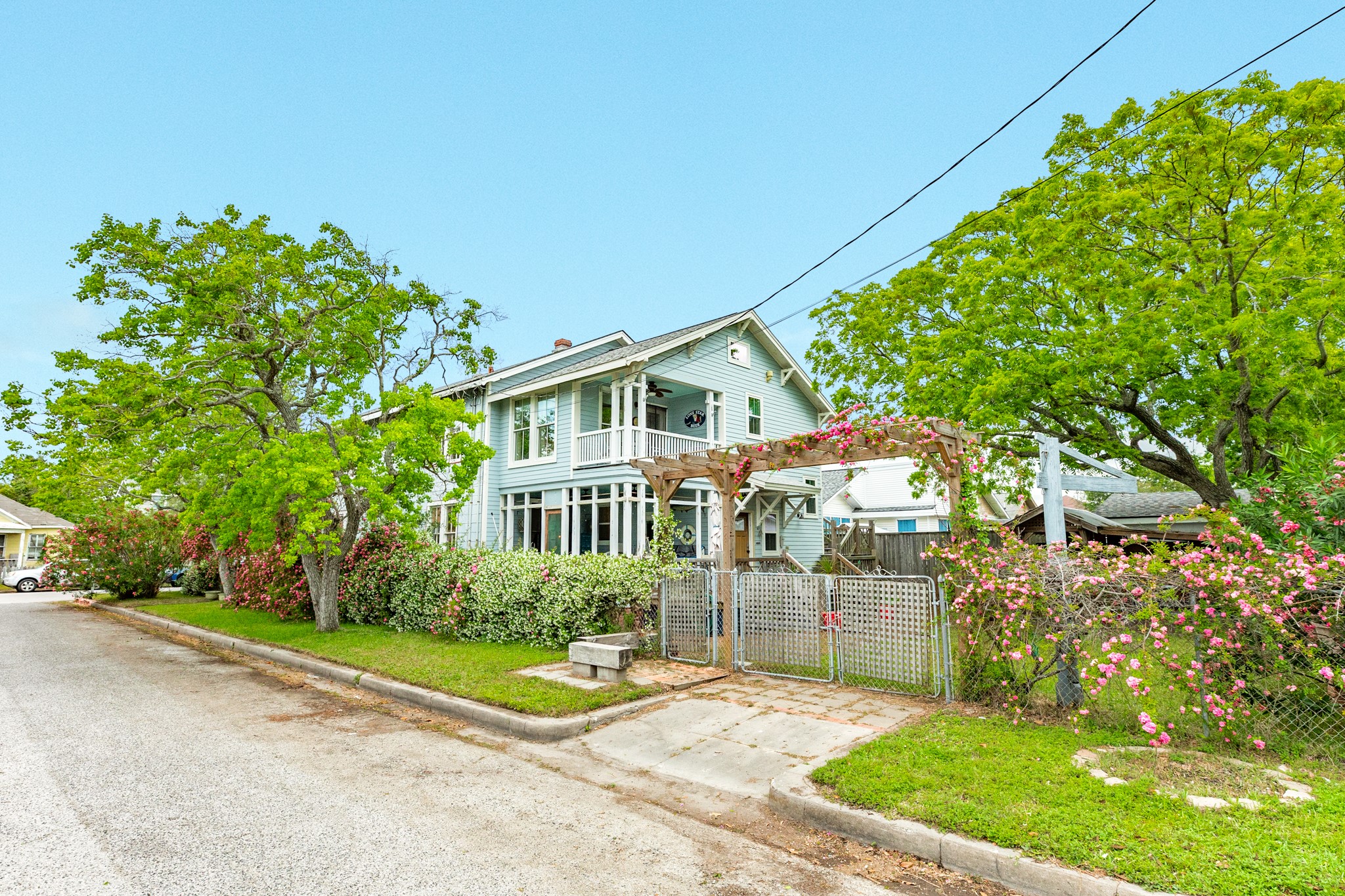 3727 Avenue R Galveston, TX 77550 - Photo 5 of 48 The home is located on a corner lot and off street parking is accessed from 38th Street. The fence and pergola on the west side is covered in gorgeous blooming peggy martin roses.