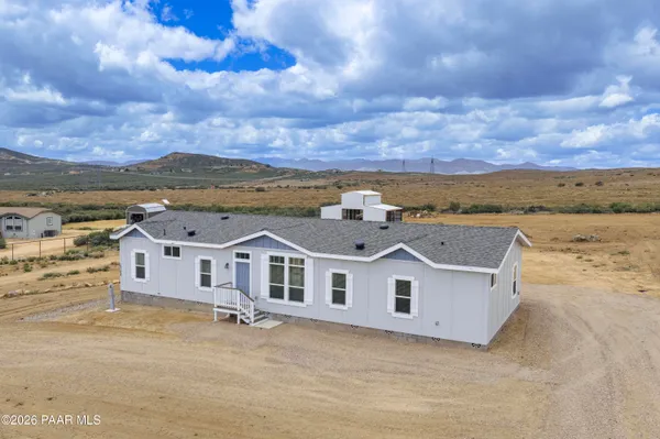 a view of a white building with a ocean view