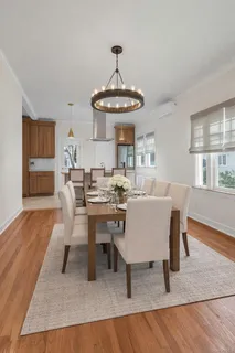 a view of a dining room with furniture window and wooden floor