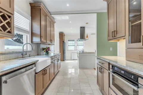 a kitchen with stainless steel appliances granite countertop a sink stove and cabinets