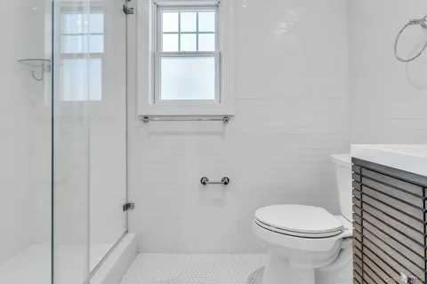 a white toilet sitting next to a bathroom sink