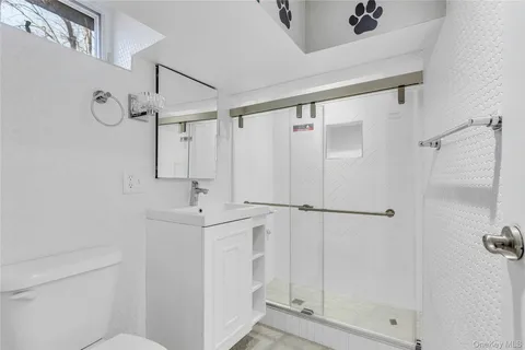 a bathroom with a sink mirror and shower