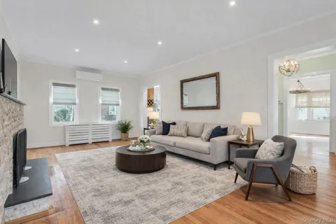 a living room with furniture a window and a fireplace