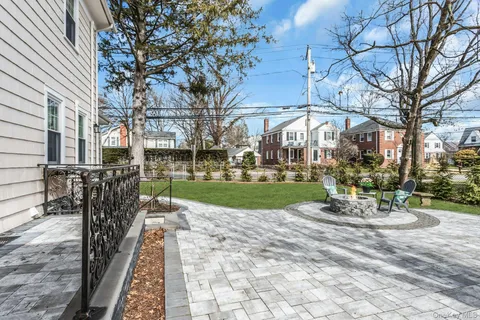 a view of a chair and table in backyard of the house