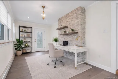 a living room with furniture a potted plant and a table