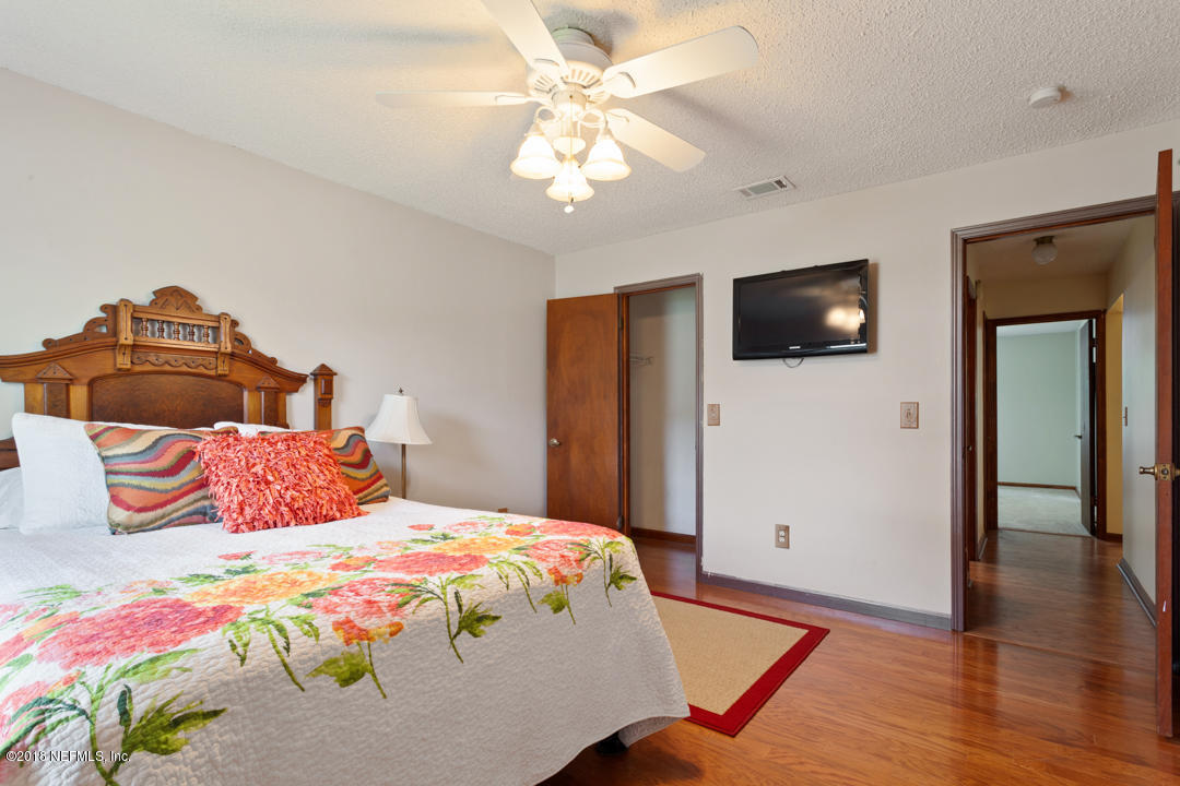 10836 Reading Road Jacksonville, FL 32257 - Photo 16 of 32 a bedroom with a bed and a flat screen tv