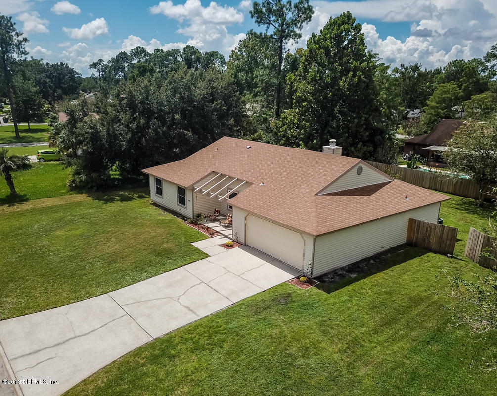 10836 Reading Road Jacksonville, FL 32257 - Photo 2 of 32 a view of a white house with a big yard and large trees