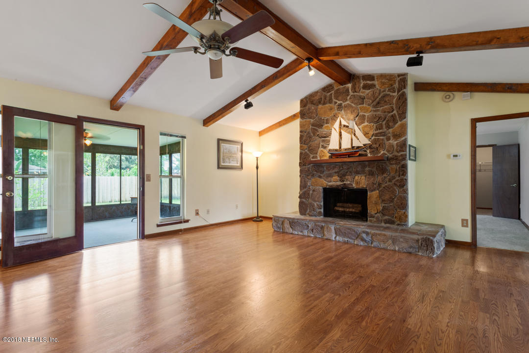10836 Reading Road Jacksonville, FL 32257 - Photo 4 of 32 a view of an empty room with wooden floor fireplace and a window