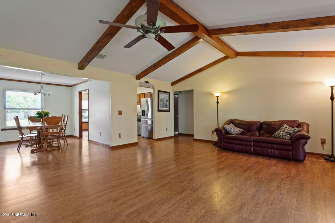 10836 Reading Road Jacksonville, FL 32257 - Photo 32 of 32 a living room with furniture and a wooden floor