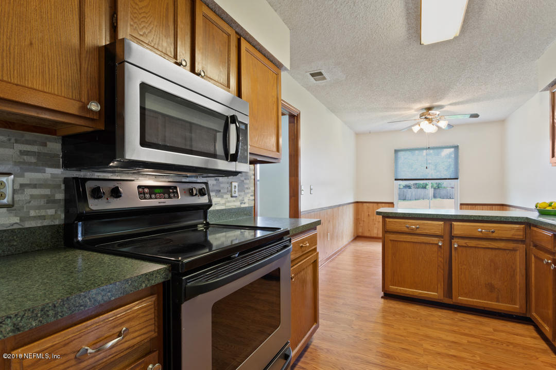 10836 Reading Road Jacksonville, FL 32257 - Photo 9 of 32 a kitchen with a stove and a microwave