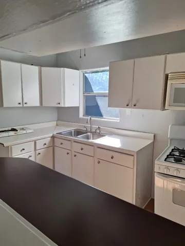 a kitchen that has a sink and a stove in it