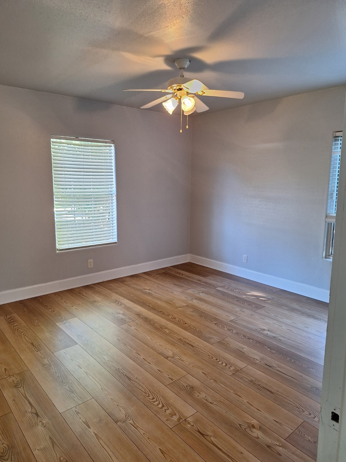 6316 Longview Street Houston, TX 77020 - Photo 2 of 6 wooden floor in an empty room with a window