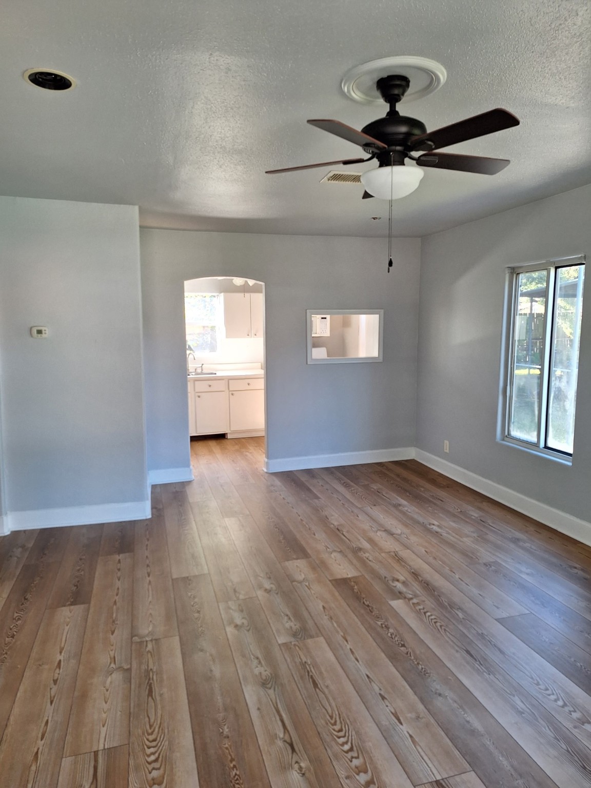 6316 Longview Street Houston, TX 77020 - Photo 5 of 6 a view of empty room with wooden floor and fan