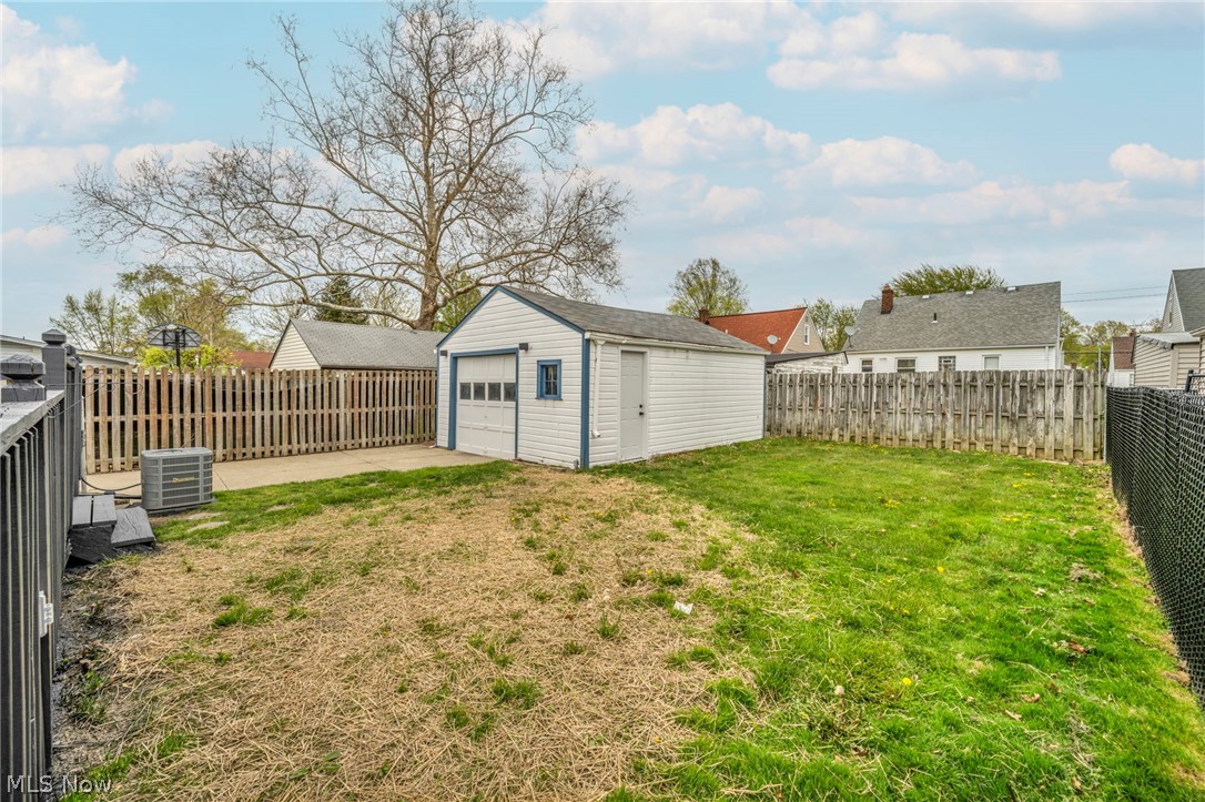 1609 Mapledale Road Wickliffe, OH 44092 - Photo 40 of 46 View of yard with a garage, central AC unit, and an outdoor structure
