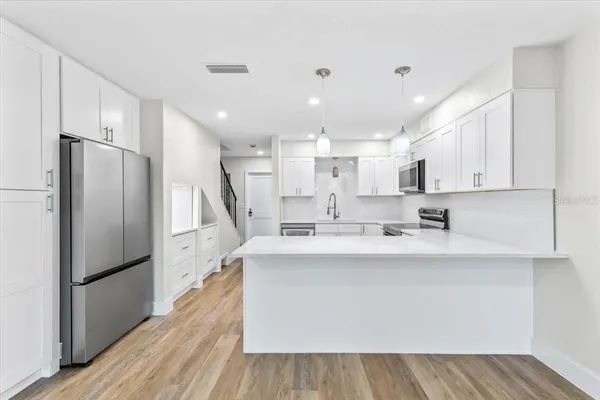 a view of kitchen with wooden floor