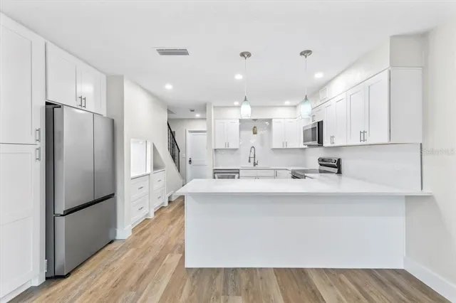 a view of kitchen with wooden floor