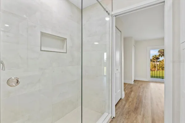 an empty room with a ceiling fan and window