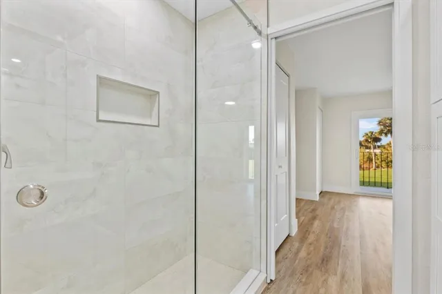 an empty room with a ceiling fan and window