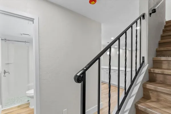 a bathroom with a shower a toilet and sink