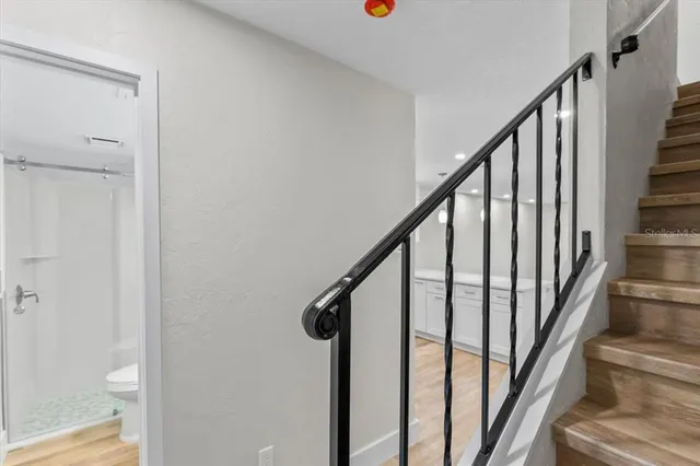 a bathroom with a shower a toilet and sink
