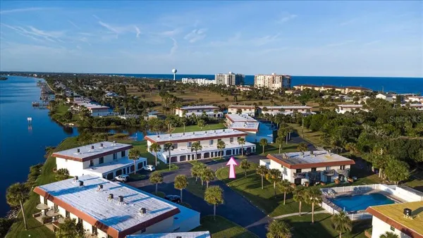 an aerial view of a house with lake view and a mountain view
