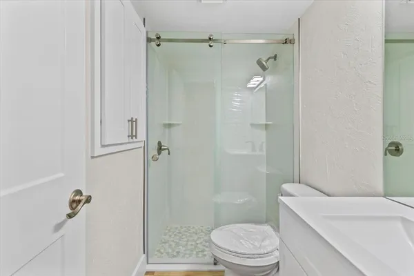 a bathroom with a sink toilet and shower