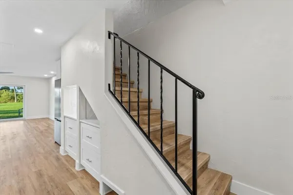 a kitchen with white cabinets and appliances
