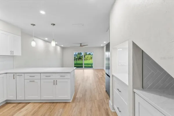 a kitchen with stainless steel appliances a stove top oven a sink a refrigerator a center island and cabinets