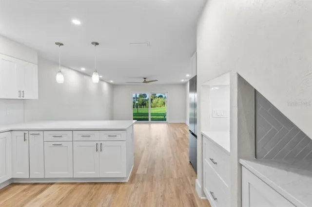 a kitchen with stainless steel appliances a stove top oven a sink a refrigerator a center island and cabinets