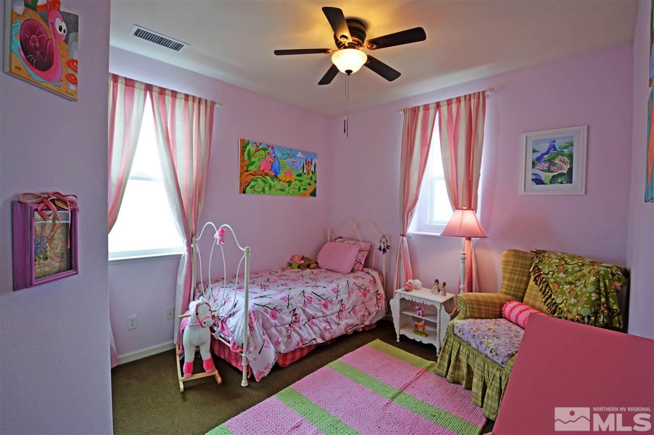 445 Manciano Way Reno, NV 89521 - Photo 16 of 28 a bedroom with a bed gym equipment and a window
