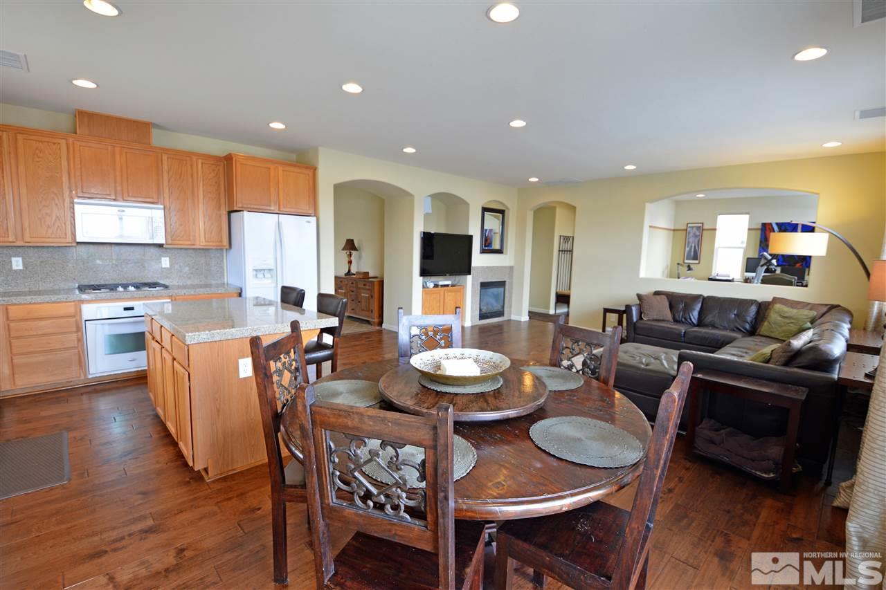 445 Manciano Way Reno, NV 89521 - Photo 5 of 28 a living room with fireplace furniture and a wooden floor