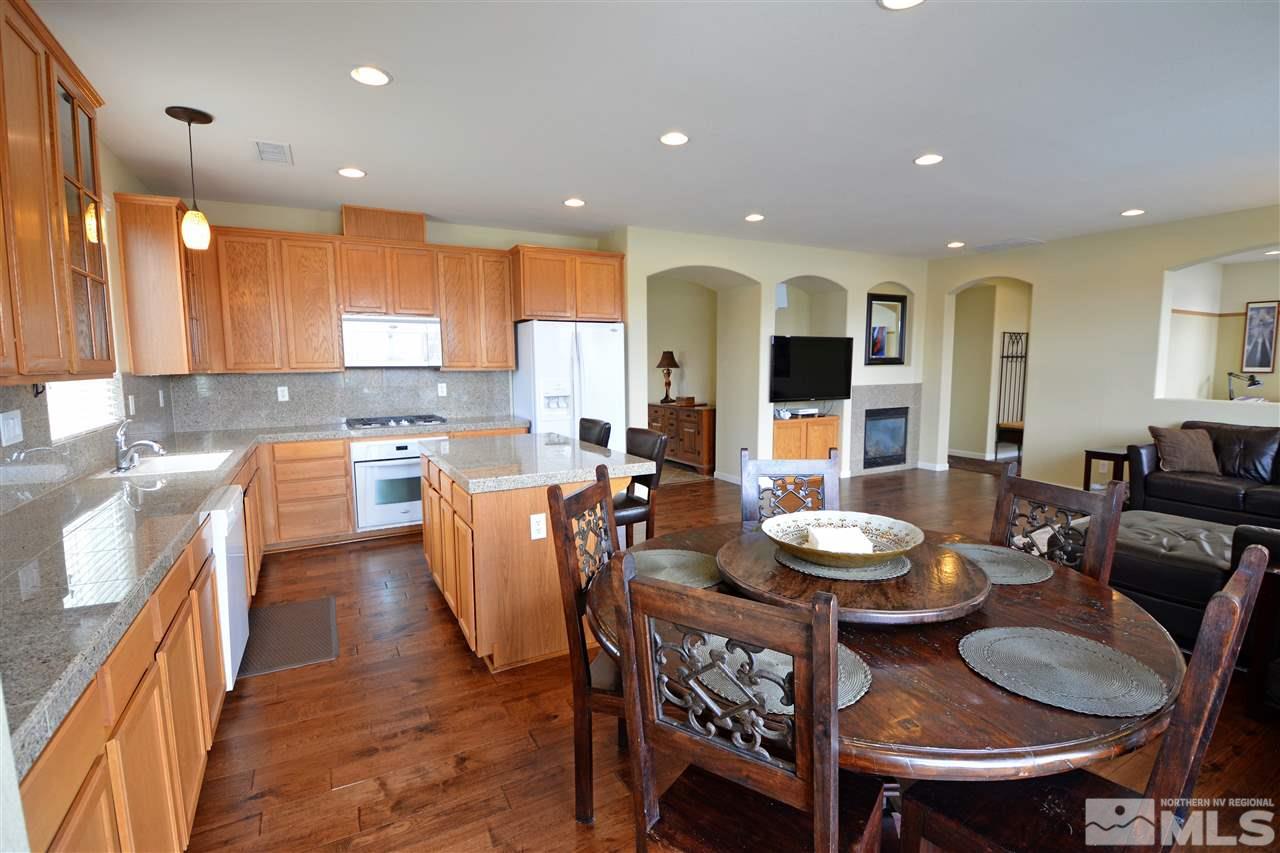 445 Manciano Way Reno, NV 89521 - Photo 6 of 28 a large kitchen with a table and chairs
