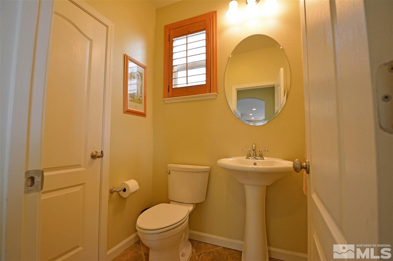 445 Manciano Way Reno, NV 89521 - Photo 10 of 28 a bathroom with a sink mirror toilet and vanity